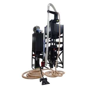 Industrial vacuum system with black metal frame, large hoses, and a wheeled floor attachment. Designed for blast room environments, this equipment features a pneumatic media recovery system with collection bin, control panel, and flexible tubing.
