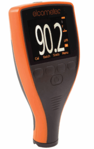 An orange and black digital gauge device, ideal for Surface Preparation, with a display reading 90.2 µm and several buttons below the screen. The brand elcometer is visible above the display.
