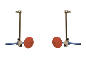 Two metal structures mounted on a wall, each holding a blue horizontal bar with a red circular pad at the end, are positioned symmetrically against a plain white background, showcasing sleek ergonomic features reminiscent of modern sandblast cabinets.