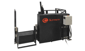 A large black industrial sandblast cabinet with the Kresco logo in orange, featuring ergonomic features, a control box on the right, and an open gate or loading compartment on the left against a white background.